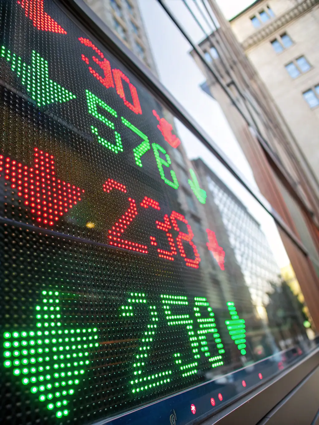 A close-up shot of stock market tickers on a digital display, symbolizing the dynamic nature of stock investments for Indian professionals.